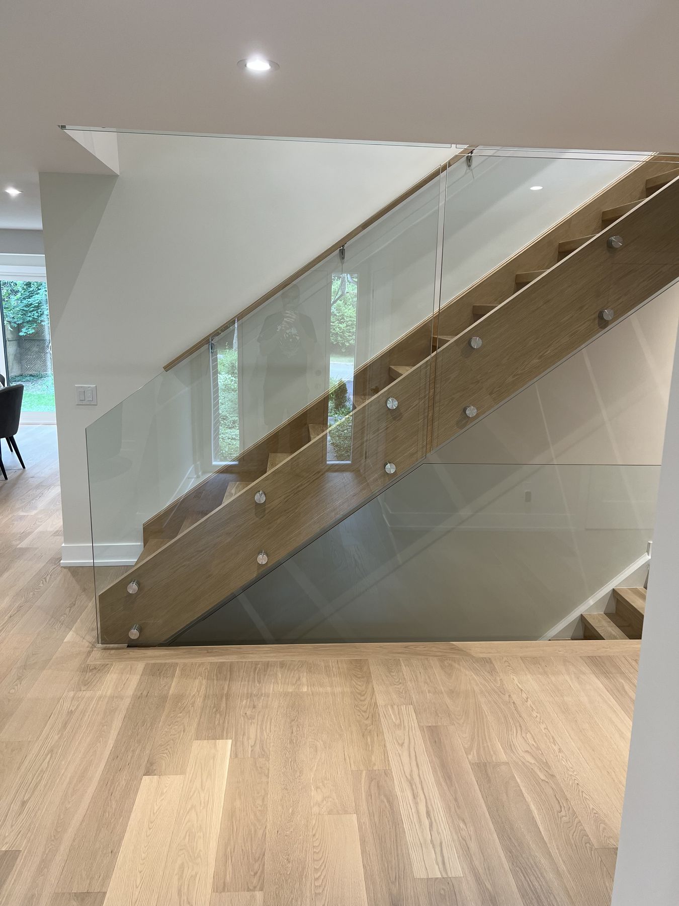 New staircase with a glass balustrade and oak floors