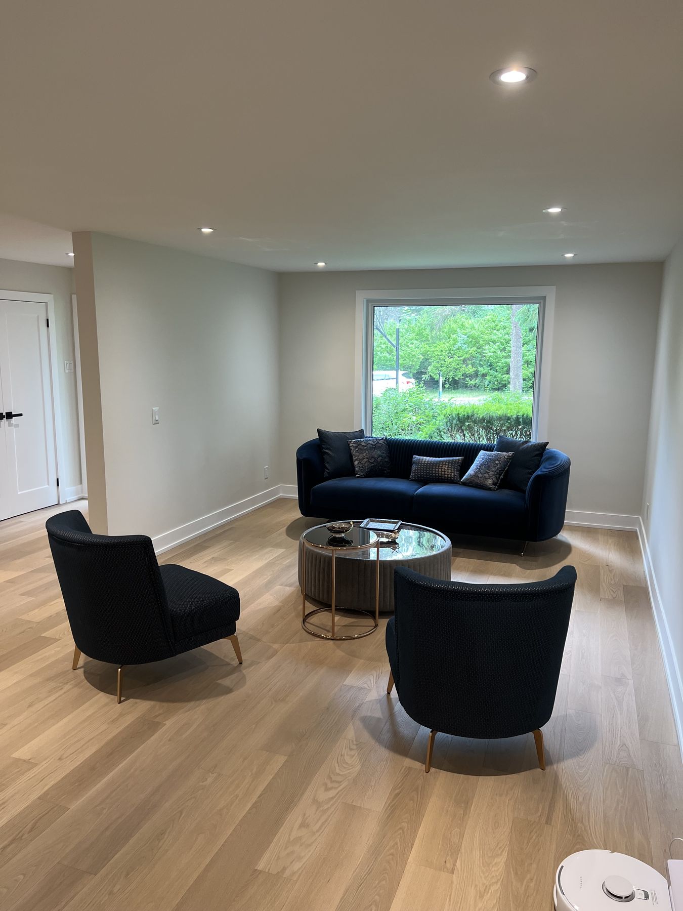 Renovated living room with oak floors and a garden window