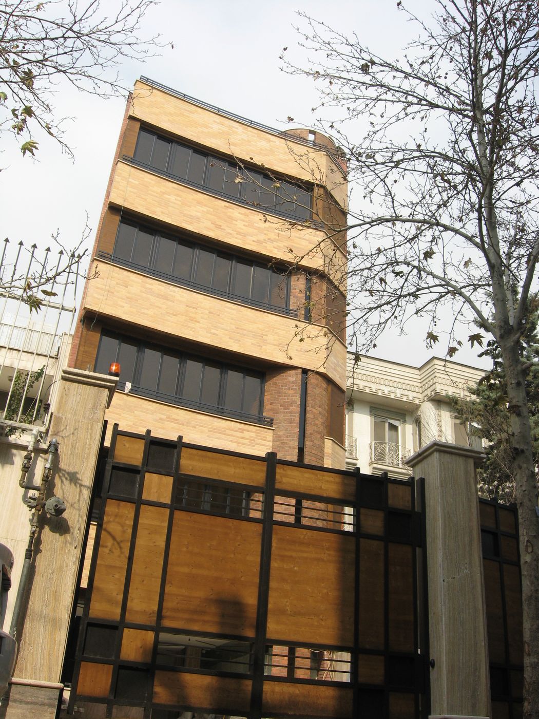 Five-storey building with a stone and glass front