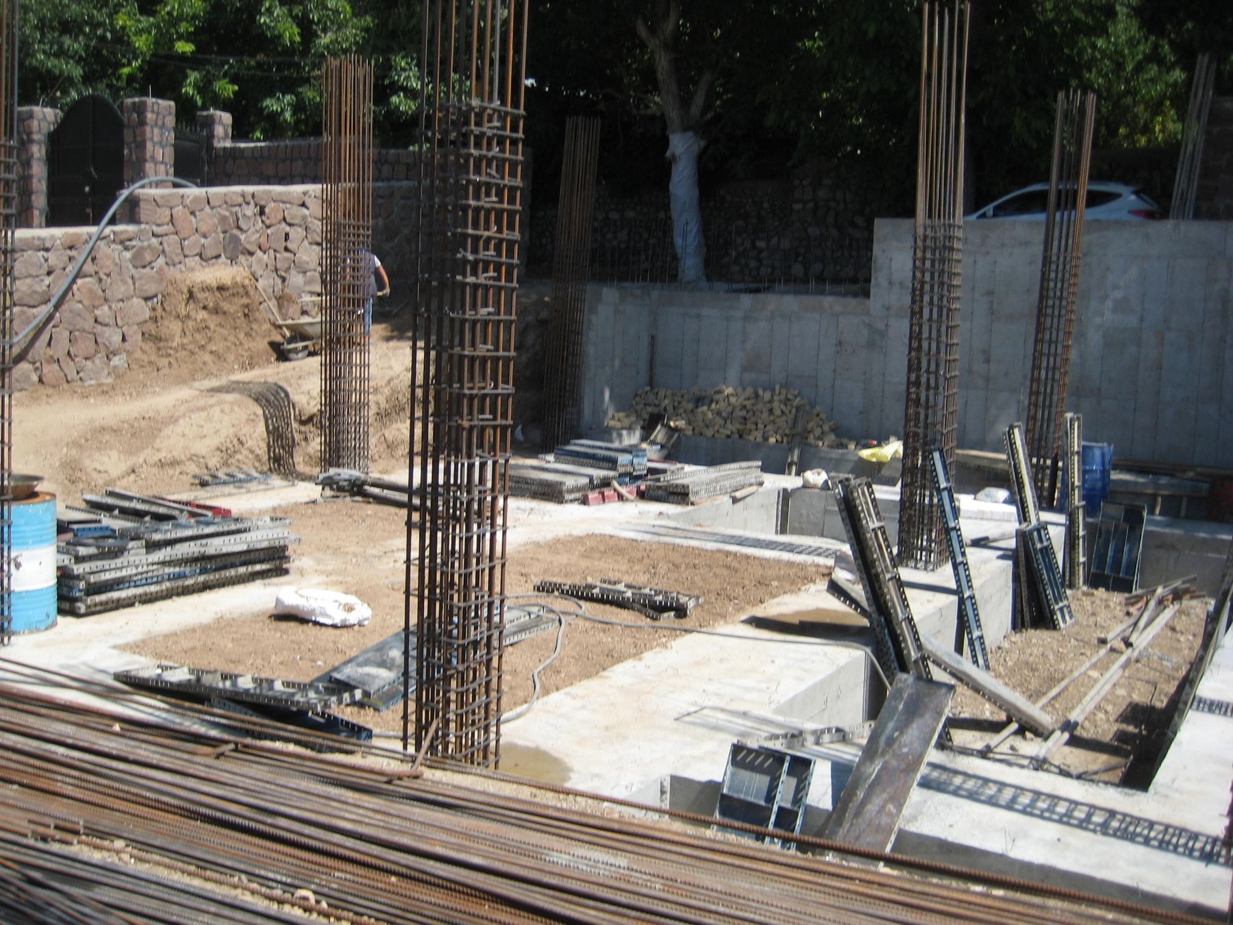 Foundation work on site with steel reinforcement cages and formwork